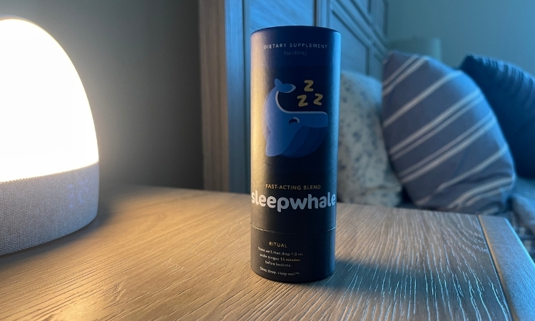 sleepwhale on night stand bed and pillows in background